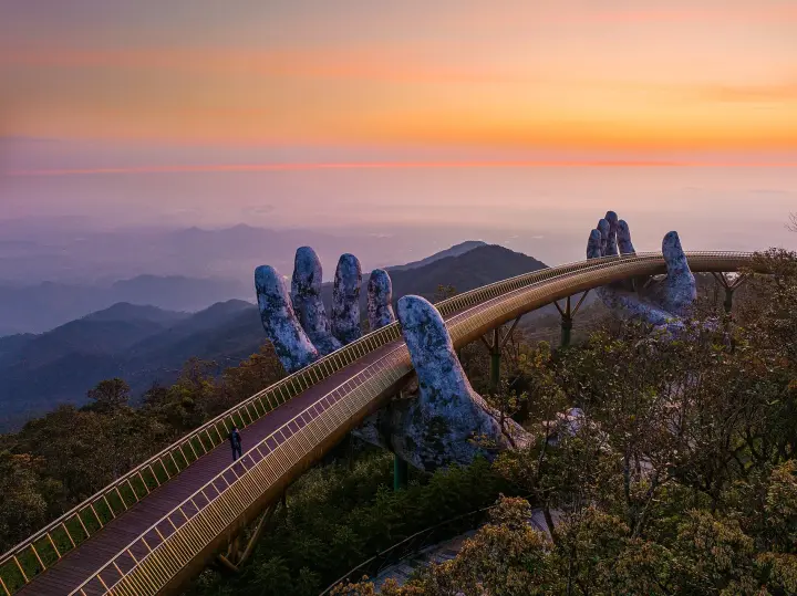 The Golden Bridge held by stone hands at Bà Nà Hills