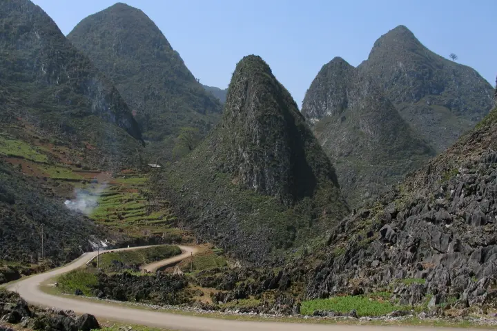 A mountain road under a blue sky near Mã Pí Lèng, Hà Giang