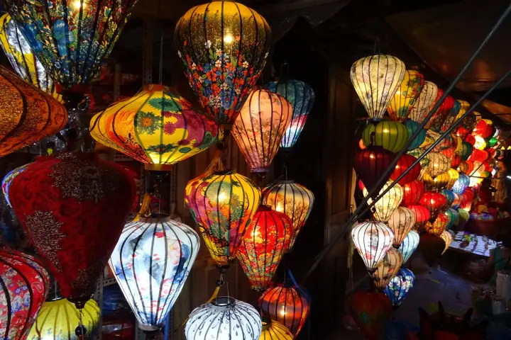 Silk lanterns lit at night in a Hội An shop