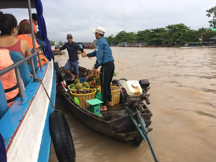 Traders selling fruit from boats at a Mekong floating market