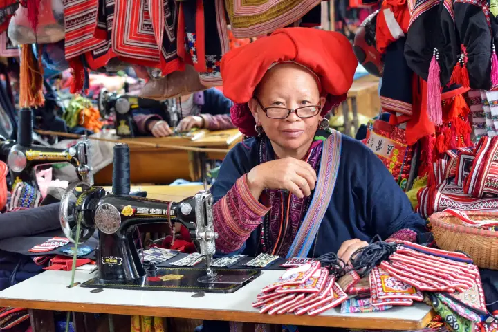 A Red Dao seamstress at her sewing machine